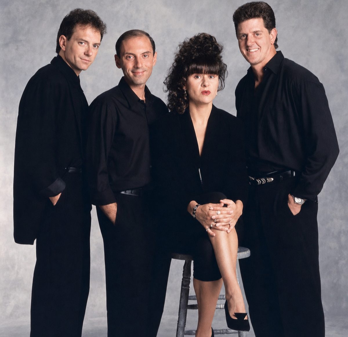The Tracey Ullman Show cast in black, photographed against a grey backdrop.